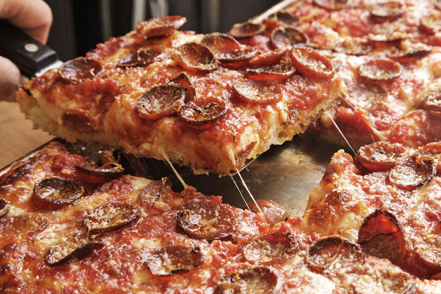 Serving slice of deep dish pizza.